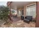 Relaxing covered porch with stone patio and outdoor seating area, perfect for entertaining at 5053 Chapel Xing, Douglasville, GA 30135