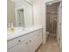 Well-lit bathroom with white vanity, a large mirror, and a tiled shower at 5053 Chapel Xing, Douglasville, GA 30135