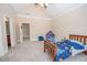 Vaulted ceiling bedroom with a single bed, ceiling fan, carpet, and ensuite bathroom access at 5053 Chapel Xing, Douglasville, GA 30135