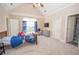 Bright bedroom with a ceiling fan, blue curtains, a large window, and an ensuite bathroom at 5053 Chapel Xing, Douglasville, GA 30135