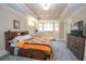 Cozy bedroom with carpet, bay window, and a dresser with mounted television at 5053 Chapel Xing, Douglasville, GA 30135