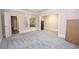 Spacious bonus room with gray floors, multiple rooms and doorways, and built-in shelving at 5053 Chapel Xing, Douglasville, GA 30135