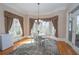 Breakfast area with a table, chairs, and large windows overlooking the wooded backyard at 5053 Chapel Xing, Douglasville, GA 30135