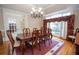 Elegant dining room features a tray ceiling, hardwood floors, and a large window with burgundy draperies at 5053 Chapel Xing, Douglasville, GA 30135