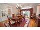 Elegant dining room with hardwood floors, tray ceiling and a large window with burgundy draperies at 5053 Chapel Xing, Douglasville, GA 30135