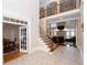 Grand foyer features a staircase with iron railings and an adjacent view into the living room at 5053 Chapel Xing, Douglasville, GA 30135