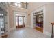 Elegant foyer with tile flooring, decorative glass door, and view into the adjacent dining room at 5053 Chapel Xing, Douglasville, GA 30135