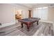 Game room with gray floors featuring a beautiful pool table and a doorway to another room at 5053 Chapel Xing, Douglasville, GA 30135