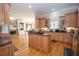 Charming kitchen with granite countertops, island cooktop, wood cabinets, and open to the breakfast area at 5053 Chapel Xing, Douglasville, GA 30135