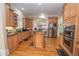 Bright kitchen with stainless steel appliances, wood cabinets, an island cooktop, and wood floors at 5053 Chapel Xing, Douglasville, GA 30135