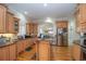 Bright kitchen with stainless steel appliances, wood cabinets, an island, and wood floors at 5053 Chapel Xing, Douglasville, GA 30135