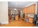 Spacious kitchen features stainless steel appliances, wood cabinets, island cooktop, and wood floors at 5053 Chapel Xing, Douglasville, GA 30135