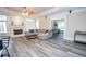 Open concept living room with a fireplace, hardwood floors, and abundant natural light at 5053 Chapel Xing, Douglasville, GA 30135