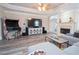 Comfortable living room featuring hardwood floors, a fireplace and an entertainment center at 5053 Chapel Xing, Douglasville, GA 30135