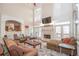 Inviting living room with a fireplace, high ceilings, and an open view to the kitchen at 5053 Chapel Xing, Douglasville, GA 30135