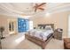 Large main bedroom with neutral walls, plush carpeting, a king size bed and tray ceiling at 5053 Chapel Xing, Douglasville, GA 30135