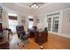 Well-lit home office with hardwood floors, ceiling fan, beautiful windows, and a classic wood desk and chair at 5053 Chapel Xing, Douglasville, GA 30135