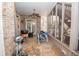 Covered patio with brick walls, ceiling fan, and stairs to access the backyard at 5053 Chapel Xing, Douglasville, GA 30135