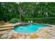 Backyard oasis featuring a gunite pool, spa, and rock waterfall feature at 5053 Chapel Xing, Douglasville, GA 30135