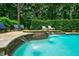 Backyard gunite pool and spa with stone waterfall, seating, and lush landscaping at 5053 Chapel Xing, Douglasville, GA 30135