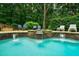 Tranquil pool area with rock features, gentle waterfalls and comfortable lounge chairs, nestled in nature at 5053 Chapel Xing, Douglasville, GA 30135