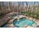 Backyard pool and hot tub, surrounded by lounge chairs and stone patio, create an inviting outdoor space at 5053 Chapel Xing, Douglasville, GA 30135