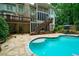 Stunning backyard with a gunite pool, stone patio, and lush landscaping at 5053 Chapel Xing, Douglasville, GA 30135