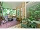 Relax on the covered porch featuring comfortable seating and stone floors at 5053 Chapel Xing, Douglasville, GA 30135