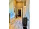 Bright bathroom hallway with a soaking tub and view of a walk-in closet at 611 Winners Cir, Locust Grove, GA 30248