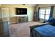 Spacious bedroom with natural lighting, a large bed and wide-screen TV for your enjoyment at 611 Winners Cir, Locust Grove, GA 30248