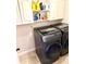 Laundry room with front load washer and dryer with storage cabinets above at 611 Winners Cir, Locust Grove, GA 30248