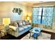 Cozy living room with a comfortable couch, glass table, and decorative artwork at 611 Winners Cir, Locust Grove, GA 30248