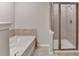 Modern bathroom features a shower with glass doors and a soaking tub at 656 Sunset Park Dr, Suwanee, GA 30024