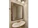 Bathroom featuring a stylish pedestal sink, framed mirror, and modern fixtures at 656 Sunset Park Dr, Suwanee, GA 30024
