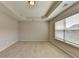 An empty bedroom features neutral walls and carpet, natural lighting and a tray ceiling at 656 Sunset Park Dr, Suwanee, GA 30024