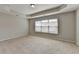 Spacious bedroom with neutral carpet and a large window at 656 Sunset Park Dr, Suwanee, GA 30024