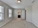 Bedroom with carpet, two windows, and a door leading to a bathroom at 656 Sunset Park Dr, Suwanee, GA 30024