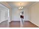 Hardwood dining room with chandelier and view into the kitchen at 656 Sunset Park Dr, Suwanee, GA 30024