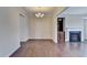 Hardwood dining area featuring a chandelier and access to the living room with fireplace at 656 Sunset Park Dr, Suwanee, GA 30024
