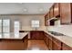 Modern kitchen features granite counters, stainless appliances, and dark wood cabinets at 656 Sunset Park Dr, Suwanee, GA 30024