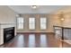 Open living room features hardwood floors, fireplace, and abundant natural light at 656 Sunset Park Dr, Suwanee, GA 30024