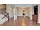Open-concept living room featuring hardwood floors and staircase to upper level at 656 Sunset Park Dr, Suwanee, GA 30024