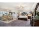 Spacious main bedroom featuring a sitting area, chandelier, and ample natural light at 1604 Falcon Ct, Locust Grove, GA 30248