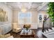 Sitting room with a coffered ceiling, wainscotting, decorative lighting, and view of the entryway at 1604 Falcon Ct, Locust Grove, GA 30248