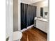 This bathroom has a sink, toilet, mirror, and bathtub with a curtain at 217 Odyssey Turn Nw, Conyers, GA 30012