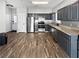 Modern kitchen featuring stainless steel appliances, sleek cabinets, and hardwood flooring at 217 Odyssey Turn Nw, Conyers, GA 30012