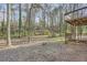 View of backyard with wooded scenery, houses, and a deck overlooking the landscape at 4716 Habersham Sw Rdg, Lilburn, GA 30047