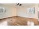 Bright bedroom with hardwood flooring, two windows, and a ceiling fan at 4716 Habersham Sw Rdg, Lilburn, GA 30047