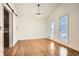 Dining room with hardwood floors, white walls, a modern chandelier, and two large windows at 4716 Habersham Sw Rdg, Lilburn, GA 30047