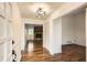 Home entryway with hardwood flooring leading to a living room featuring a brick fireplace at 4716 Habersham Sw Rdg, Lilburn, GA 30047